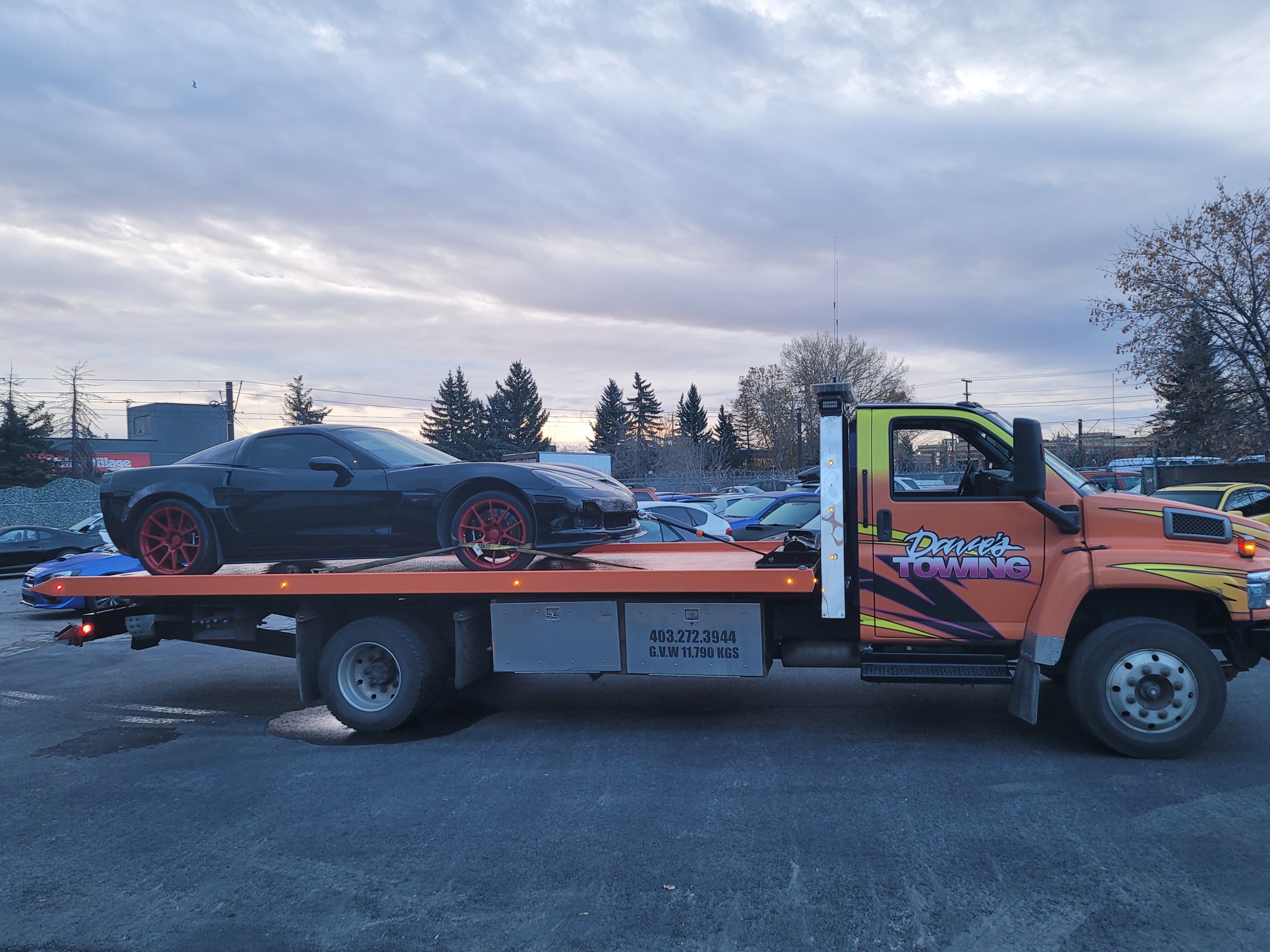Flatbed towing a classic truck in Diamond Valley
